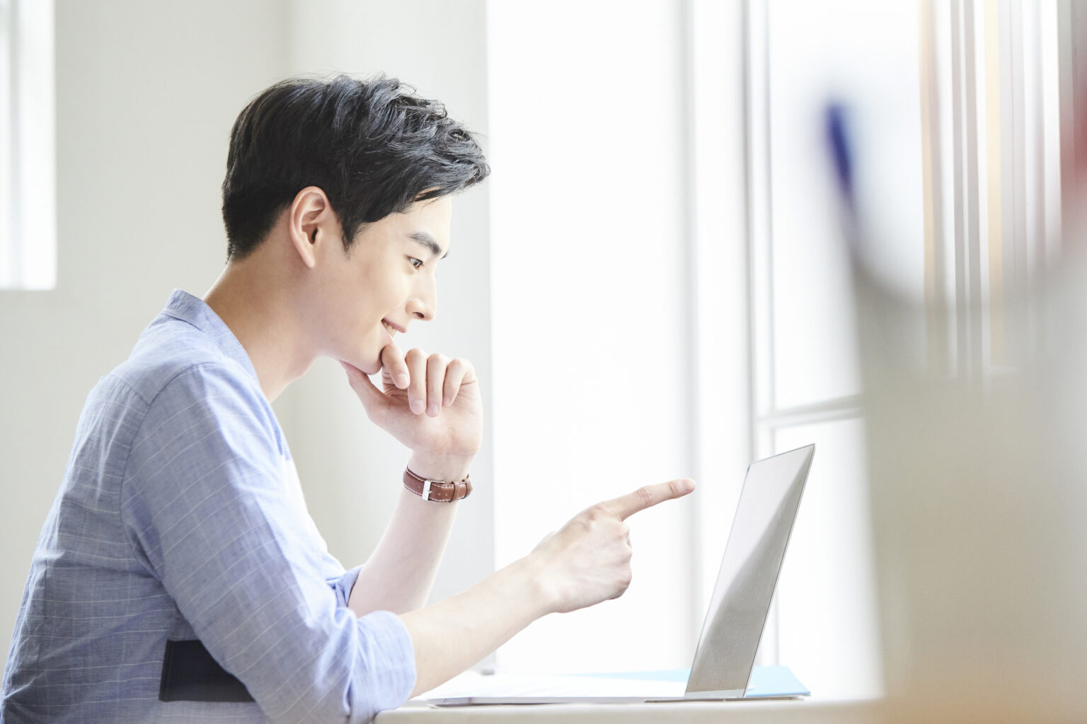 パソコンを見てアイデアを思いつく男性